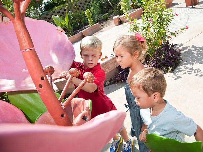 Children outdoors playing with an interactive display