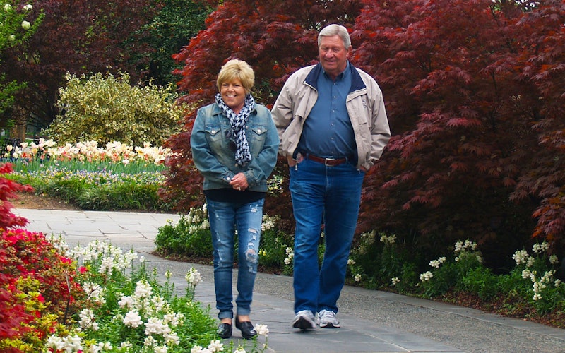 Couple walking through a garden