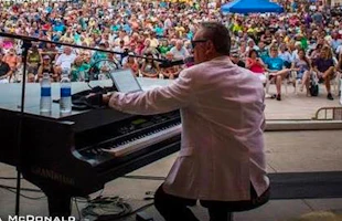 Turnstiles singer on stage with a piano in front of a crowd
