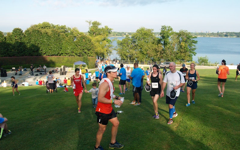 runners walk on a lawn after a race.